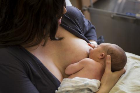 mom with baby feeding at her breast