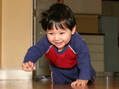 toddler crawling on the floor and smiling