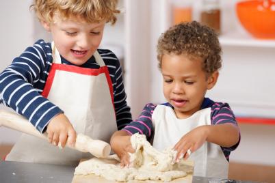 toddlers with rolling pin and dough